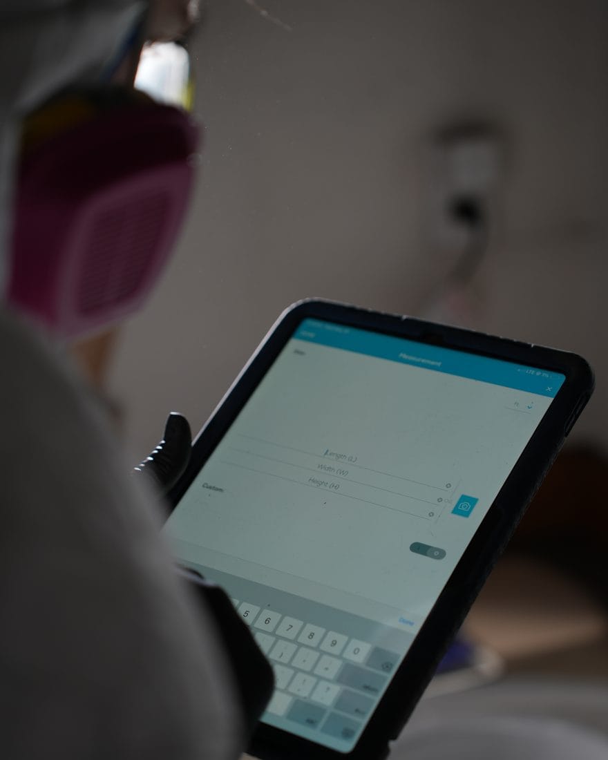 A Superior Contents technician logging each item into the digital inventory on a tablet