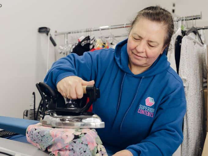A Superior Contents technician pressing and restoring a garment in the textile room